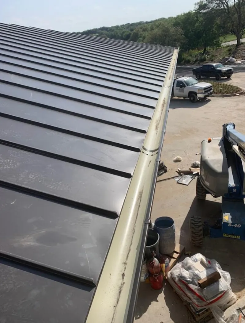 Standing seam panel and gutter detail on a metal roofing jobsite in Plumstead